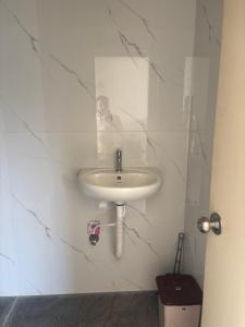 a man taking a picture of a bathroom sink at Laya hotels in Chintāmani
