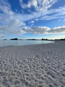 a sandy beach with the ocean in the background at Congiu's Apartments in Pula