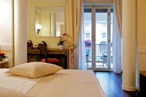 Postel nebo postele na pokoji v ubytování Hotel Stendhal