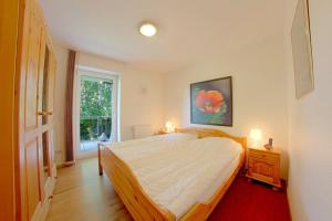 a bedroom with a large bed and a window at Lilli Marleen WE 26 in Wremen