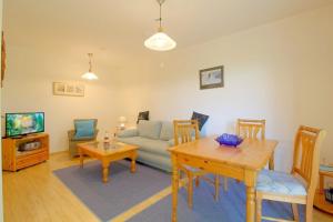 a living room with a couch and a table at Lilli Marleen WE 26 in Wremen
