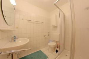 a bathroom with a sink and a toilet and a shower at Lilli Marleen WE 26 in Wremen