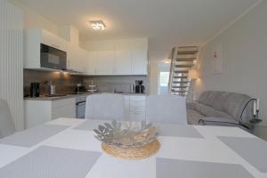 a kitchen and living room with a table and chairs at KW4 Haus Anna in Dorum-Neufeld