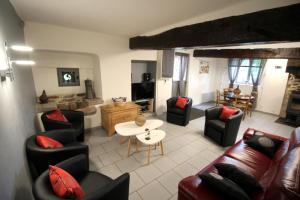 a living room with a couch and chairs and a table at Les moissonneurs in Champagnac-la-Rivière