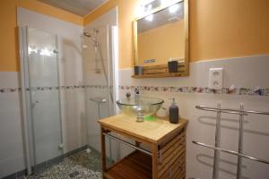 a bathroom with a glass bowl sink and a shower at Les moissonneurs in Champagnac-la-Rivière +36 photos