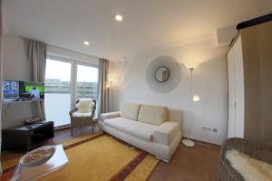 a living room with a white couch and a window at NS 6a Seestern Wremen in Wremen