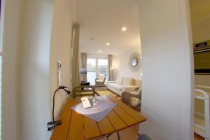 a living room with a table and a couch at NS 6a Seestern Wremen in Wremen