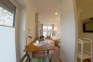 a small living room with a table and chairs at NS 6a Seestern Wremen in Wremen
