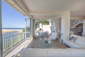 a living room with a couch and a view of the beach at 53 Island Road in Seafield