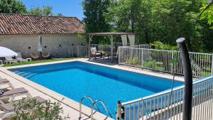 a swimming pool in a yard with a gazebo at Gîte du Clos de Gamel in Lascabanes