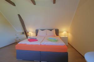 a bedroom with a bed with two pillows on it at Gästehaus Dorum 05 in Dorum