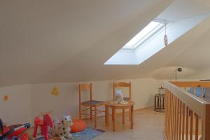a attic room with a skylight and a table and chairs at LT35 Bungalow Moritz in Dorum-Neufeld