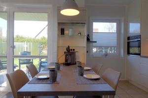 a dining room with a table and chairs in a kitchen at SI5-01 Terrassenwohnung Deichnah in Cappel-Neufeld
