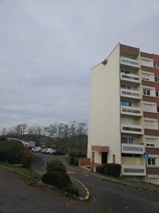 a building on the side of a road next to a street at Appartement T2 in Le Creusot