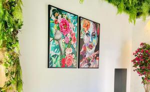 three framed pictures on a wall with flowers at Sveltos Residence Suites in Larnaca