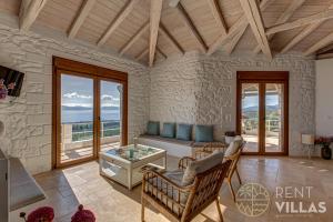 a living room with a couch and a table at Villa Karima with Sea View in Metókhion