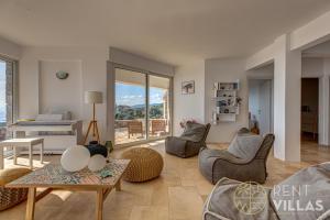 a living room with a couch and a table at Villa Karima with Sea View in Metókhion +36 photos