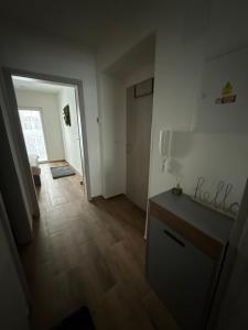 an empty room with a kitchen and a hallway at Apartmán ALEX Choceň in Choceň +3 photos