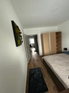 a small bedroom with a bed and a hallway at Apartmán ALEX Choceň in Choceň