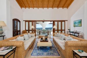 a living room with two couches and a table at Spartilas Villas in Pyrgi