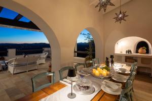 a dining room with a table and chairs with a view at Spartilas Villas in Pyrgi