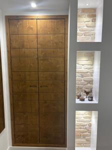 a wooden cabinet in a room with a stone wall at B&B Dimora della Fonte in Roccaraso +7 photos