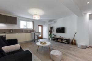 a living room with a couch and a table at Cosy Home in Antibes