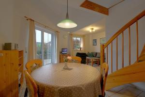 a dining room table with a vase of flowers on it at STW28a Delphin in Dorum-Neufeld