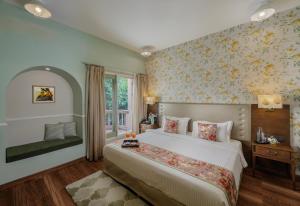 a bedroom with a large bed and a window at Karma Chalets in Gurgaon +182 photos