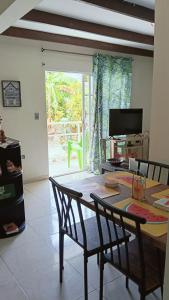 a dining room with a table and chairs and a television at Mayo´s Place in San Andrés