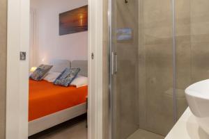 a bathroom with a shower and a bed with two pillows at Salaqua Bed and Breakfast in Torre Mozza +224 photos