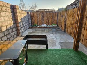 a backyard with a wooden fence and green grass at For Family in Aparan +5 photos