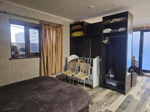 a bedroom with a bed and two chairs and a window at For Family in Aparan