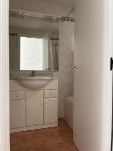 a bathroom with a sink and a mirror at El Chalet de Lola in Playa de Miramar +28 photos