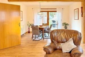 a living room with a leather chair and a table at Landlust in Lübbenau