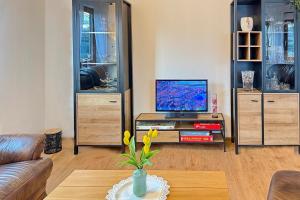 a living room with a tv on a table at Landlust in Lübbenau