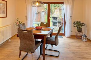 a dining room with a wooden table and chairs at Landlust in Lübbenau