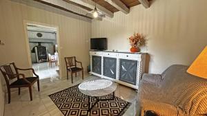 a living room with a couch and a table at Les tâches in Pensol