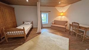 a bedroom with a bed and a table and a chair at Les tâches in Pensol