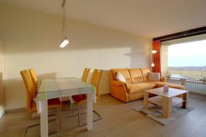 a living room with a table and a couch at Apartment 545 in Hohegeiß