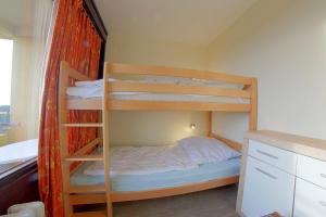 a bedroom with two bunk beds and a desk at Apartment 545 in Hohegeiß +2 photos
