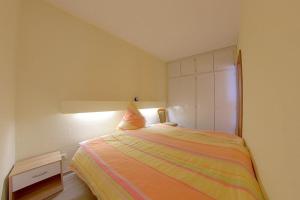 a small bedroom with a bed and a cabinet at Apartment 545 in Hohegeiß
