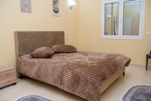 a bedroom with a bed with two pillows on it at Dar Gamra in Tozeur +27 photos