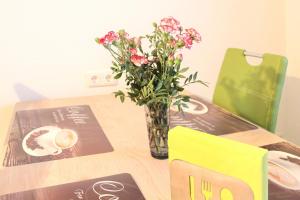 a vase of flowers sitting on top of a table at Spreemitte in Lübbenau +18 photos