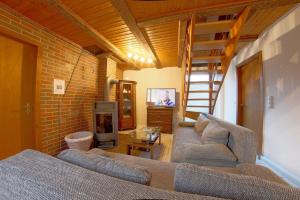 a living room with two couches and a fireplace at Dat lütte Hus in Dorum