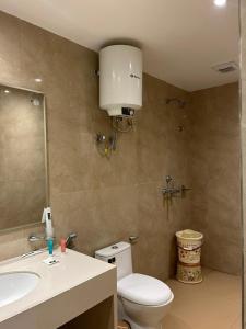 a bathroom with a white toilet and a sink at Hotel President in Agra
