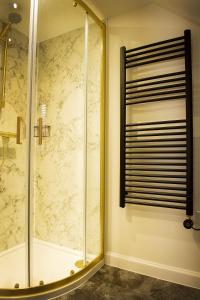 a bathroom with a shower with a glass door at Coorie-In Cottage in Whitehills +32 photos