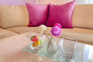 a table with two vases and flowers on it at Wildbiene in Lübbenau