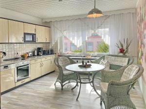 a kitchen with a table and chairs in a kitchen at Wildbiene in Lübbenau