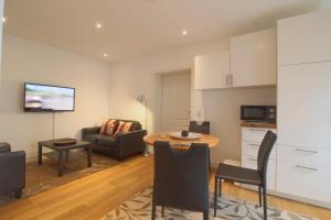 a kitchen and living room with a table and a couch at NS 6 Strandläufer Wremen in Wremen